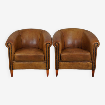 Set of 2  sheepskin leather club armchairs with a beautiful vintage look