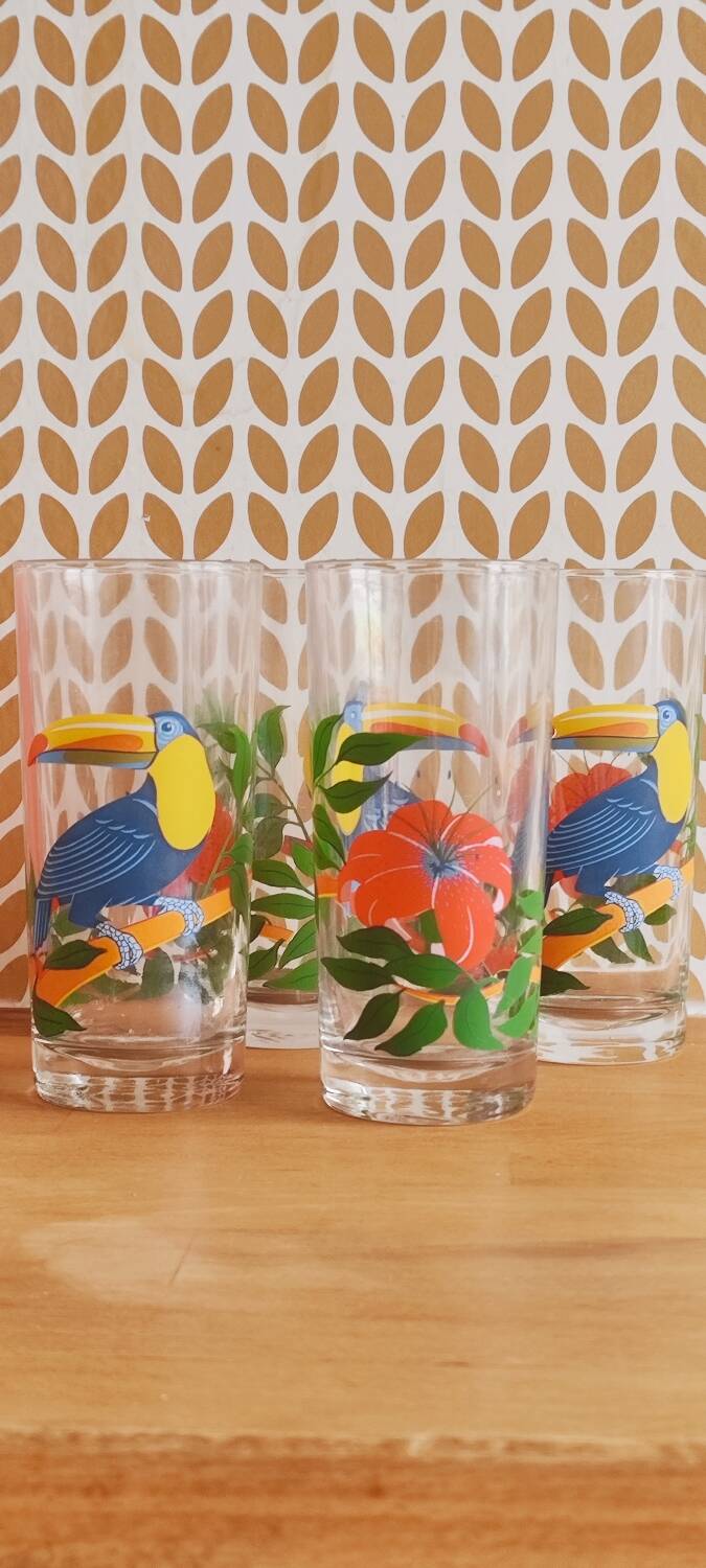 Vintage lemonade glasses with tropical parrot and flower patterns.