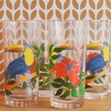 Vintage lemonade glasses with tropical parrot and flower patterns.