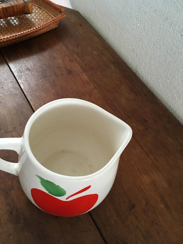 Vintage pitcher with apple decoration.