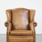 Patinated sheep leather wingback armchair
