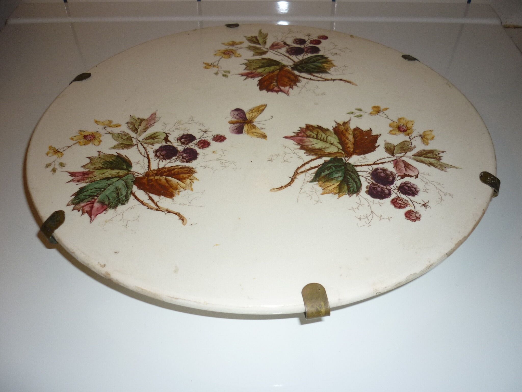 Ceramic plate underside on bronze stand