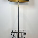 Designer floor lamp in black lacquered metal and brass, incorporating a magazine rack