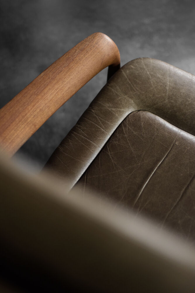 High teak and brown leather armchair with reclining backrest, mid-century Danish style, 1960s.