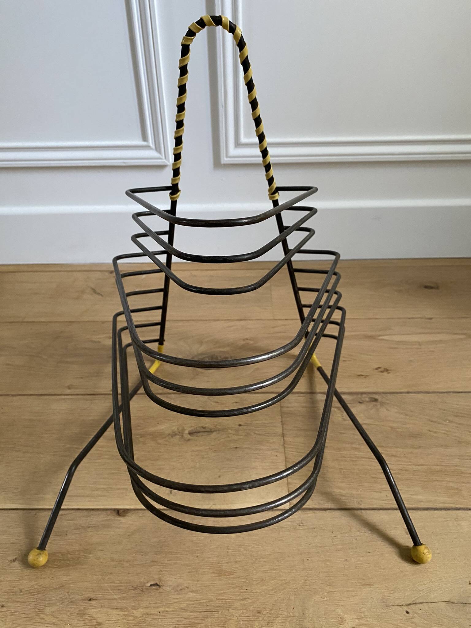 Black metal vinyl record holder and yellow scoubidou from the 60s