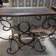 Pair of wrought iron and blackened wood consoles from the mid-20th century.