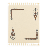 Ecru Berber rug with symbolic corner patterns.