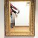 Mirror with large molded frame in gilded plaster with gold leaf