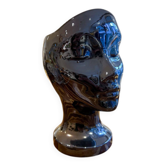 Black ceramic vase with a woman's face.