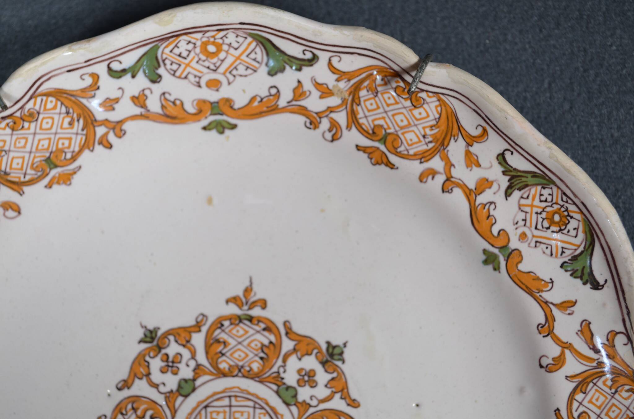 Two 18th century earthenware plates with grand feu decoration in ochre, green and manganese