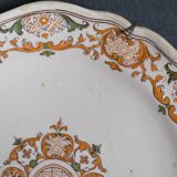 Two 18th century earthenware plates with grand feu decoration in ochre, green and manganese
