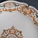 Two 18th century earthenware plates with grand feu decoration in ochre, green and manganese