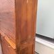 Vintage 1940s secretary desk with wooden curtains, storage, and shutters.