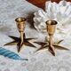 Duo of brass star candlesticks