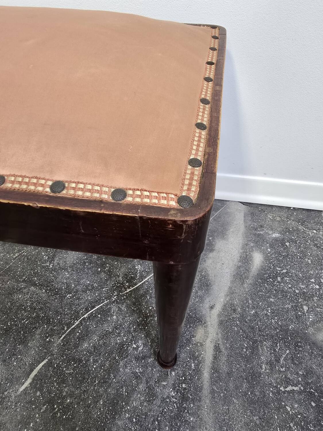 Vintage wooden ottoman from the 1940s with a silk top and studded trim.