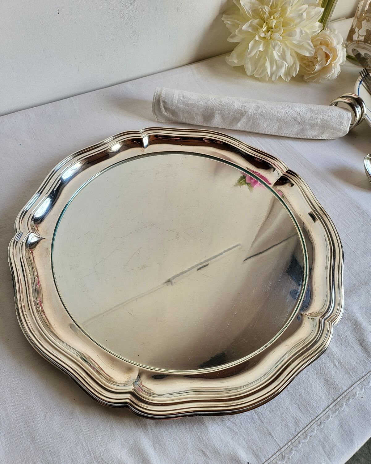 Round silver-plated serving dish with a glass base.