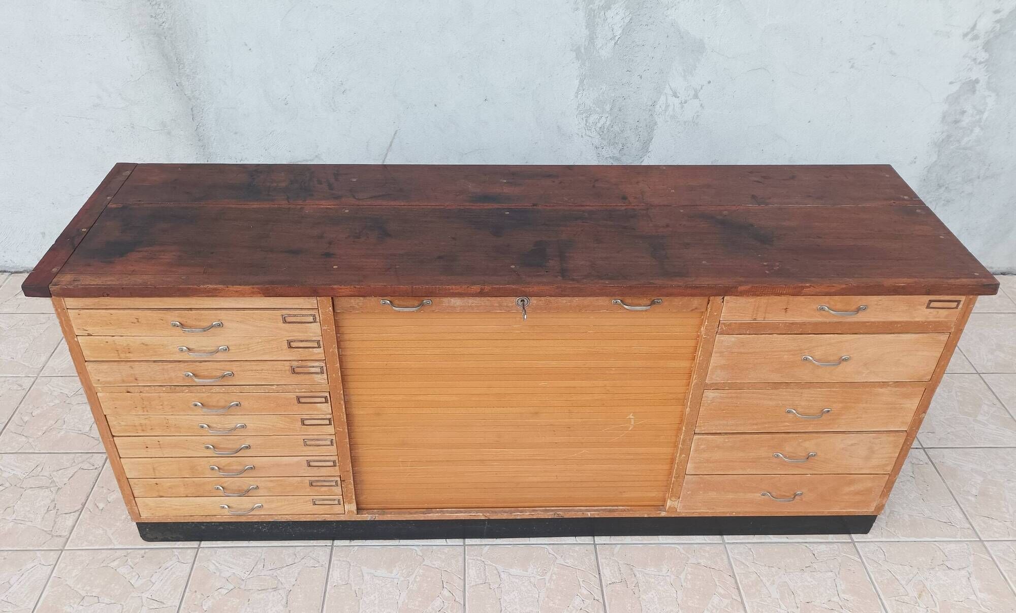 Workshop furniture with drawers and curtain in beech and walnut.