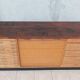 Workshop furniture with drawers and curtain in beech and walnut.