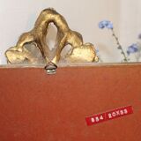 Small rectangular mirror in gilded wood with a pediment decorated with flowers