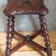 Antique stool in turned and carved solid wood