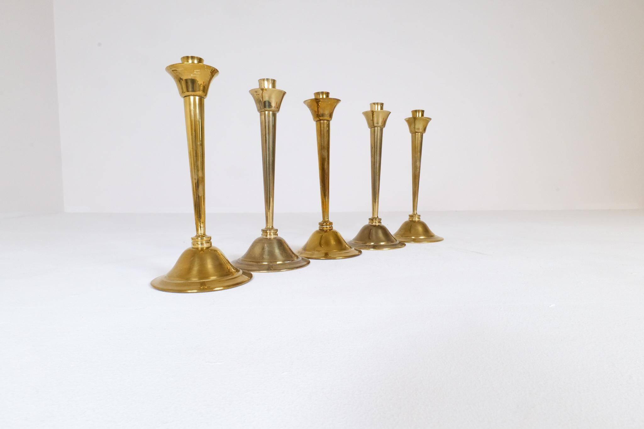 Mid-century set of 5 brass candlesticks by Lars Holmström, Arvika, Sweden.