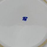 Old earthenware dish with a floral basket decoration.