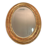 Golden oval mirror