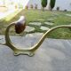 Pair of Art Nouveau coat hooks in bronze and chestnut, circa 1930.