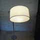 Flexible floor lamp, chrome, opaque white shade with metallic edges.