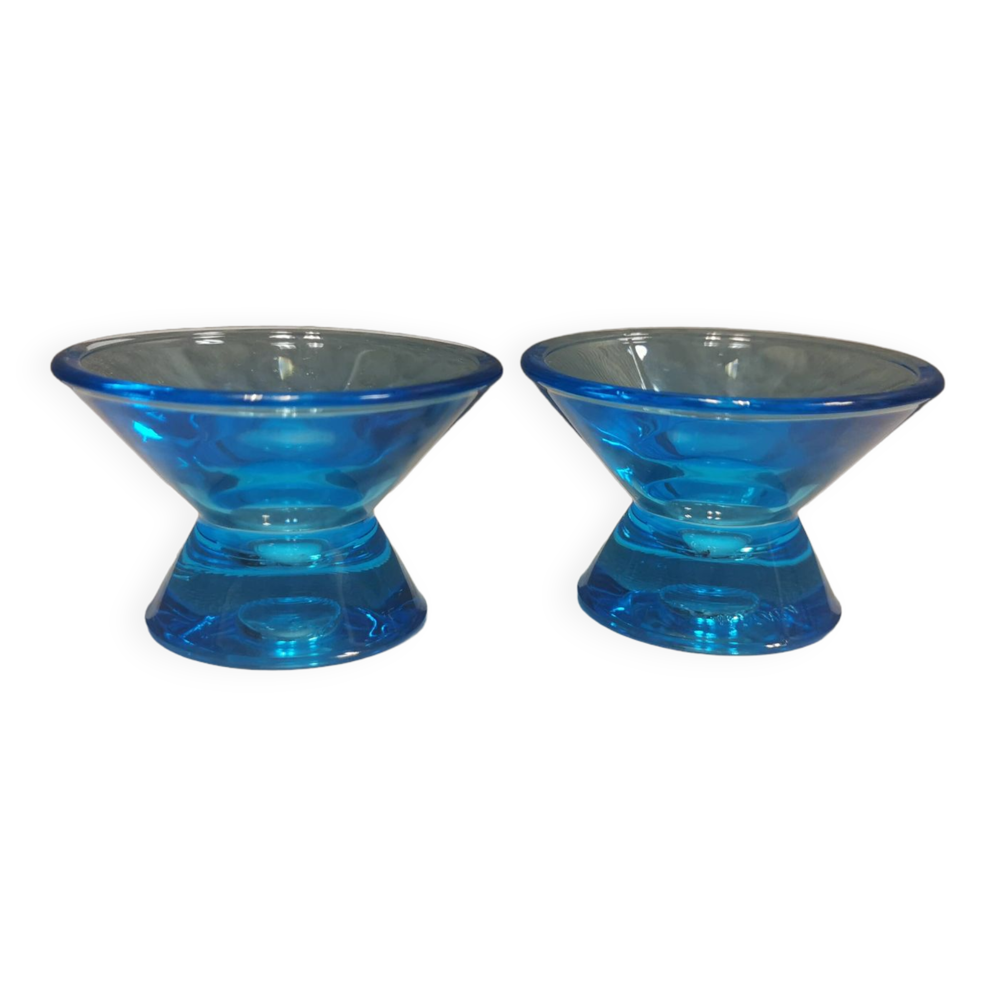 Two small candle holders in blue glass from the well-known Finnish company Ittala.