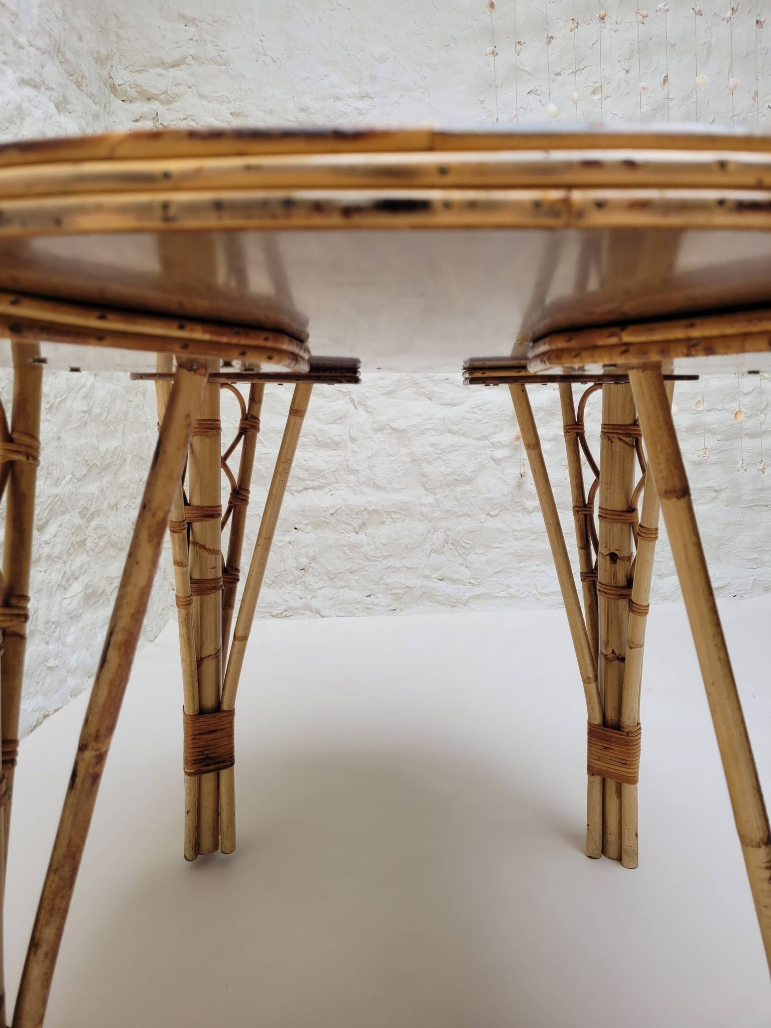 Vintage Audoux Minet bamboo, rattan, and smoked glass table duo.