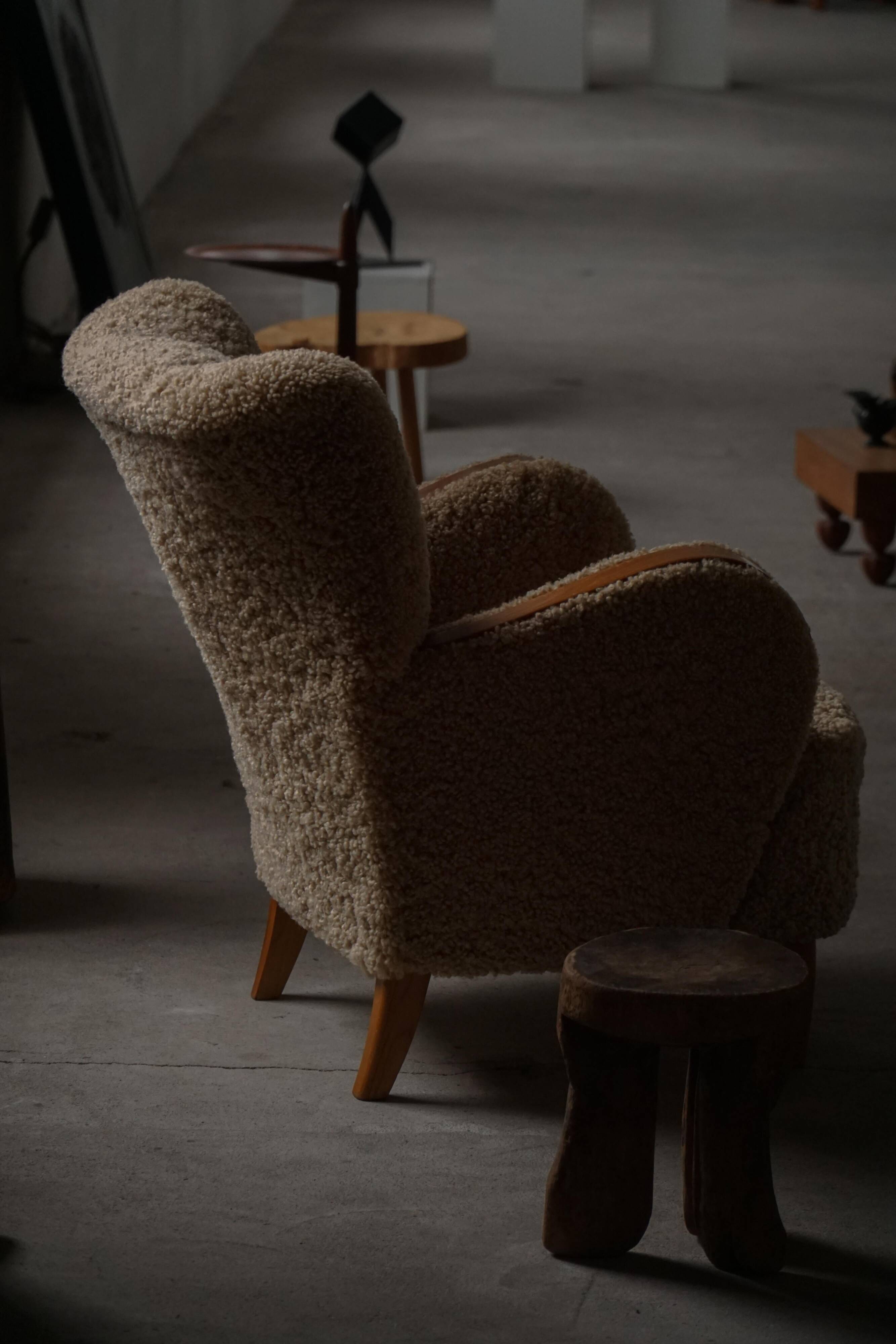 Pair of Danish Art Deco modern lounge chairs in sheepskin with lambswool and elm, 1940s.