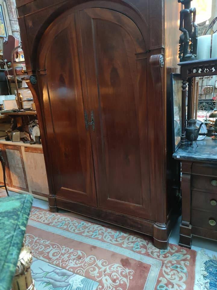 A walnut wardrobe with marquetry and boxwood stringing, dating from the Consulate period, circa 1810.