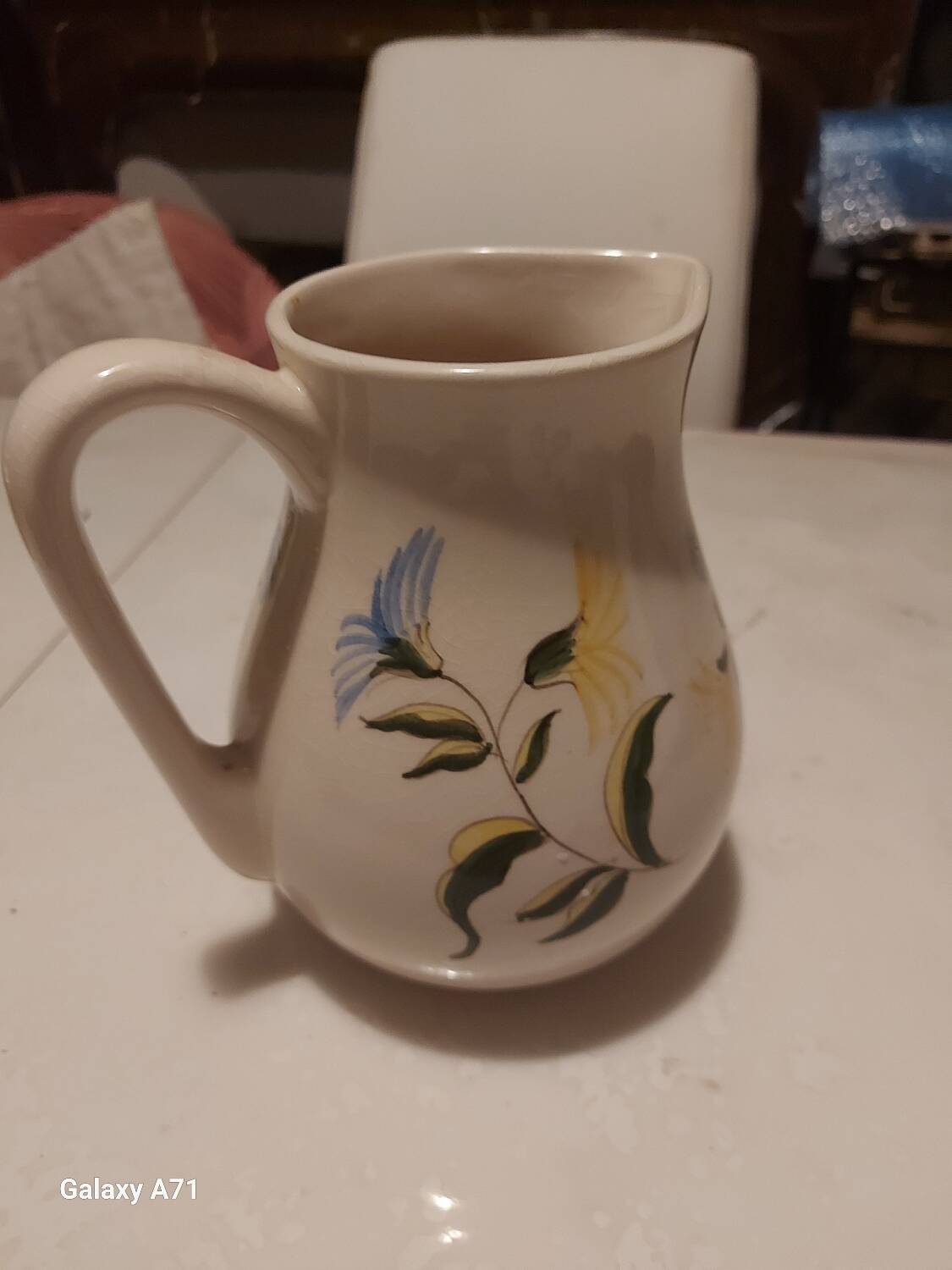 Earthenware pitcher with floral motifs in the Moustiers style, signed.