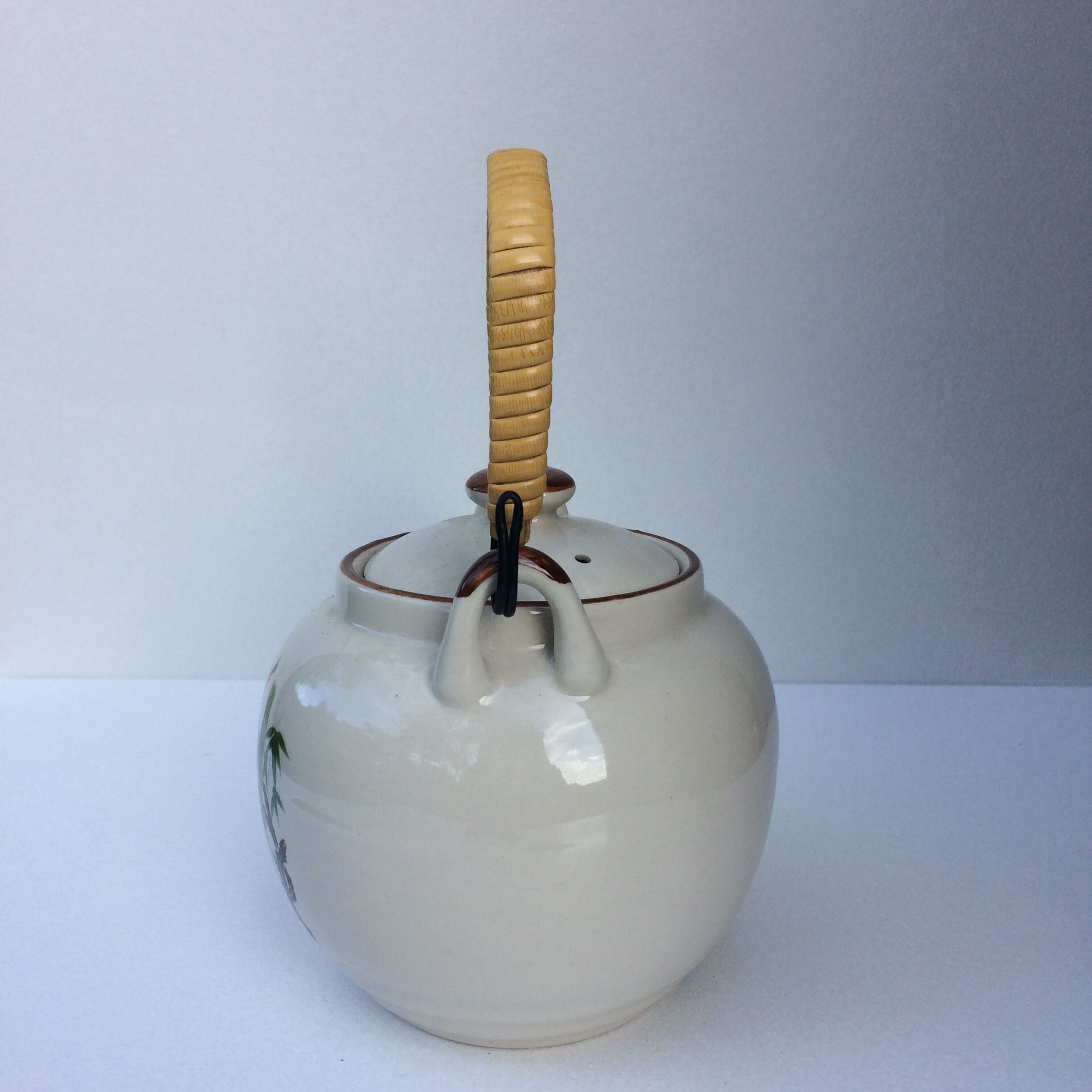 Vintage teapot with wicker handle