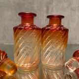 Pair of Baccarat twisted tinted crystal bottles
