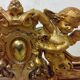 Antique mirror with a gilded frame and cherubs.