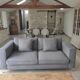 Three-seater grey mottled fabric sofa