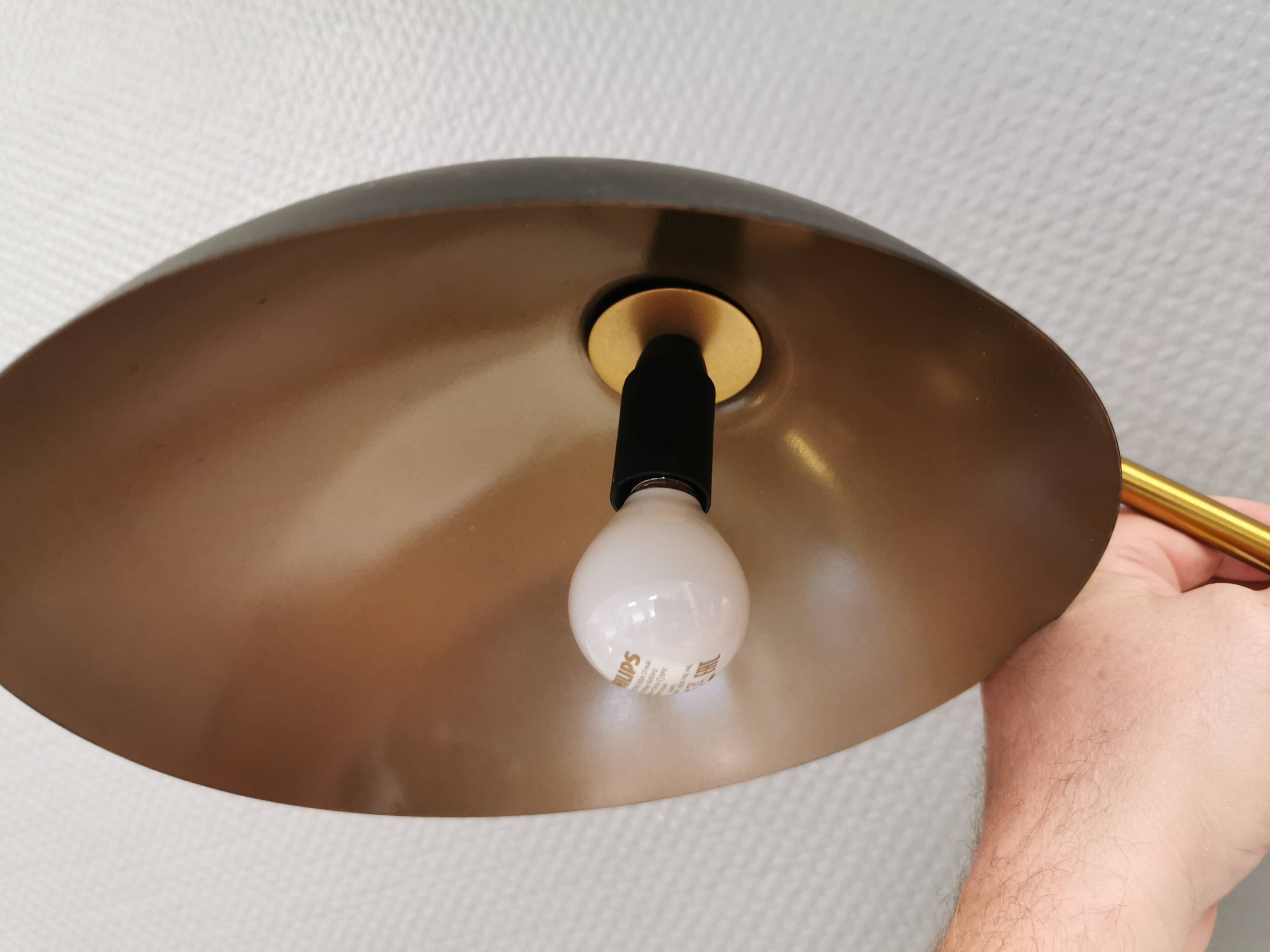 A wall lamp in black and brass-coloured finishes. Danish, early 2000s.