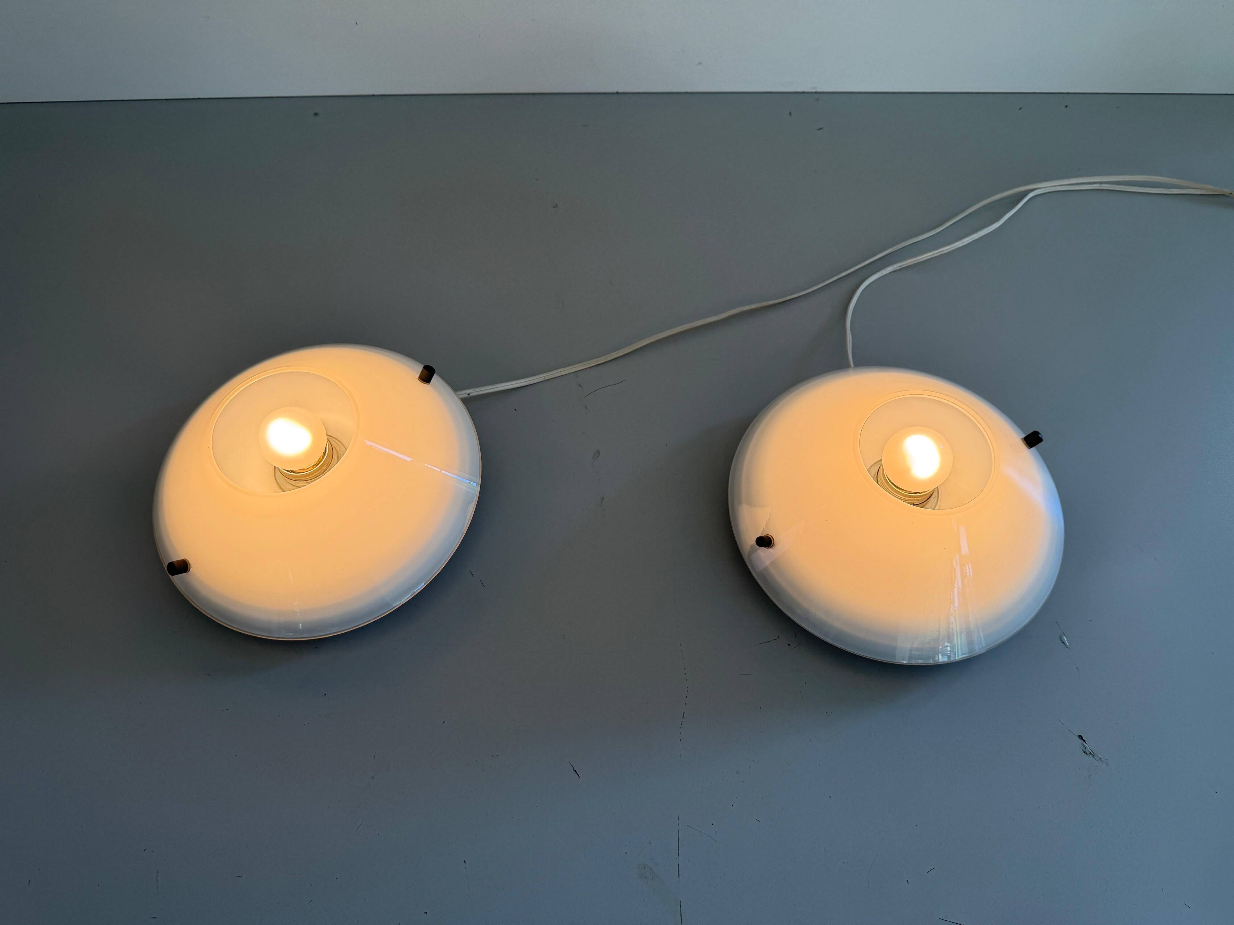 Pair of opal glass wall lights from the mid-century by Lamperti, 1960s, Italy.