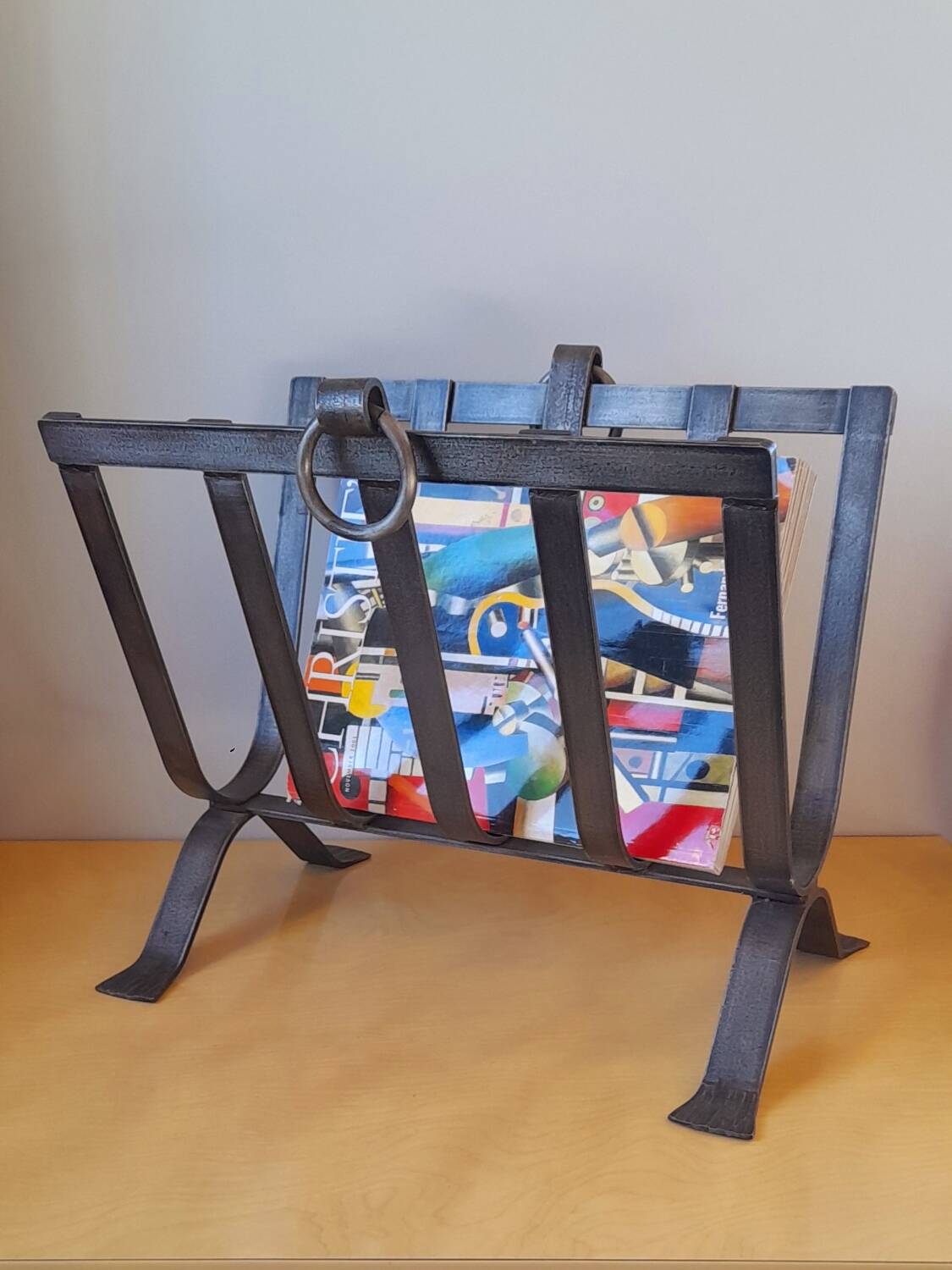 Brutalist magazine rack in forged steel, 1950.
