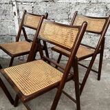Serie de 8 chaises pliantes vintage en bois et cannage 1960