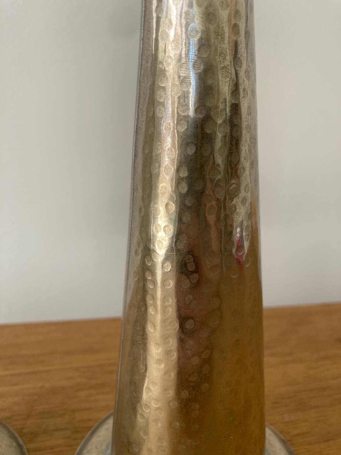 Pair of hammered metal candlesticks