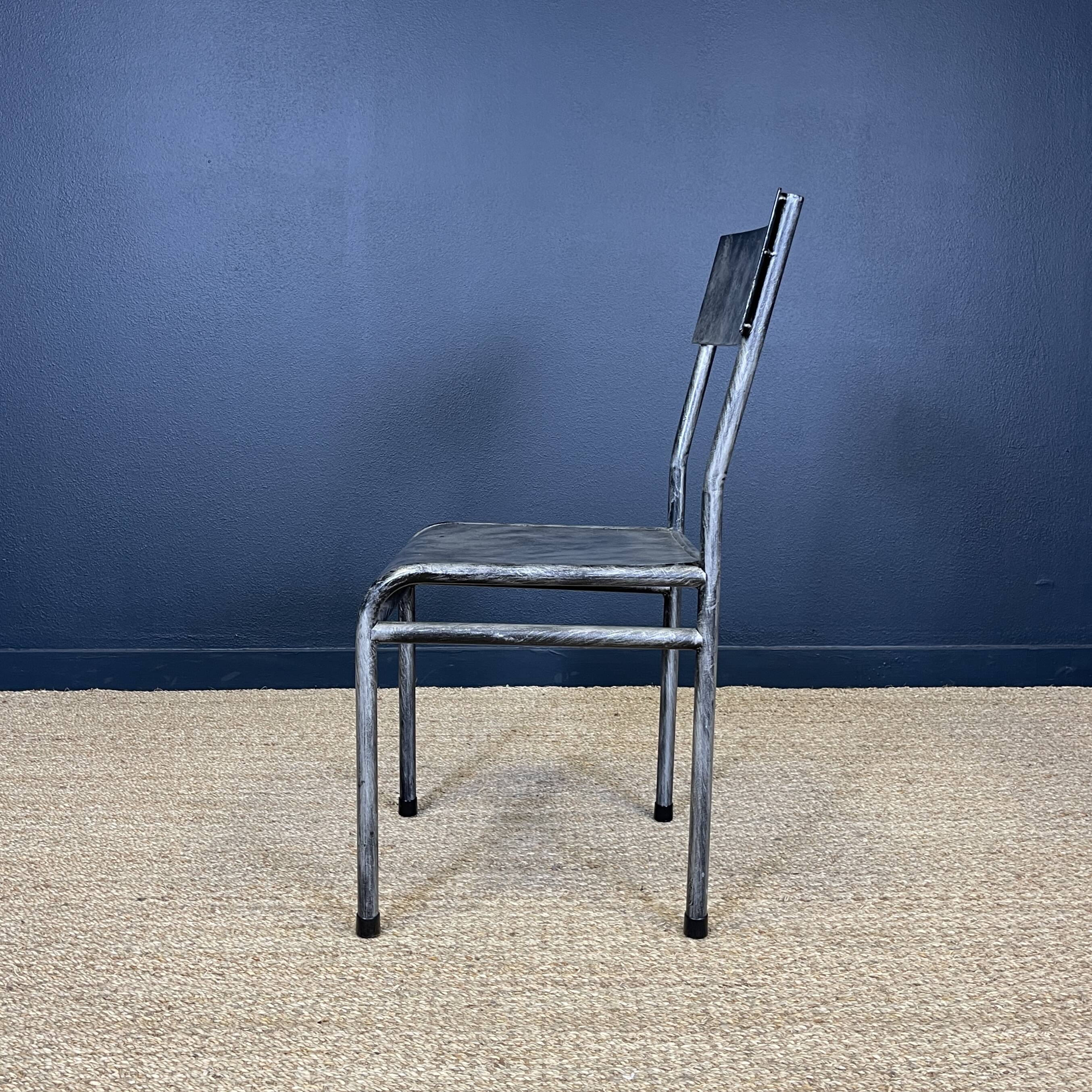 Pair of gray metal industrial chairs