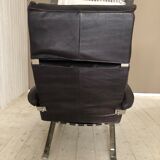Grained leather armchair with rocking movement