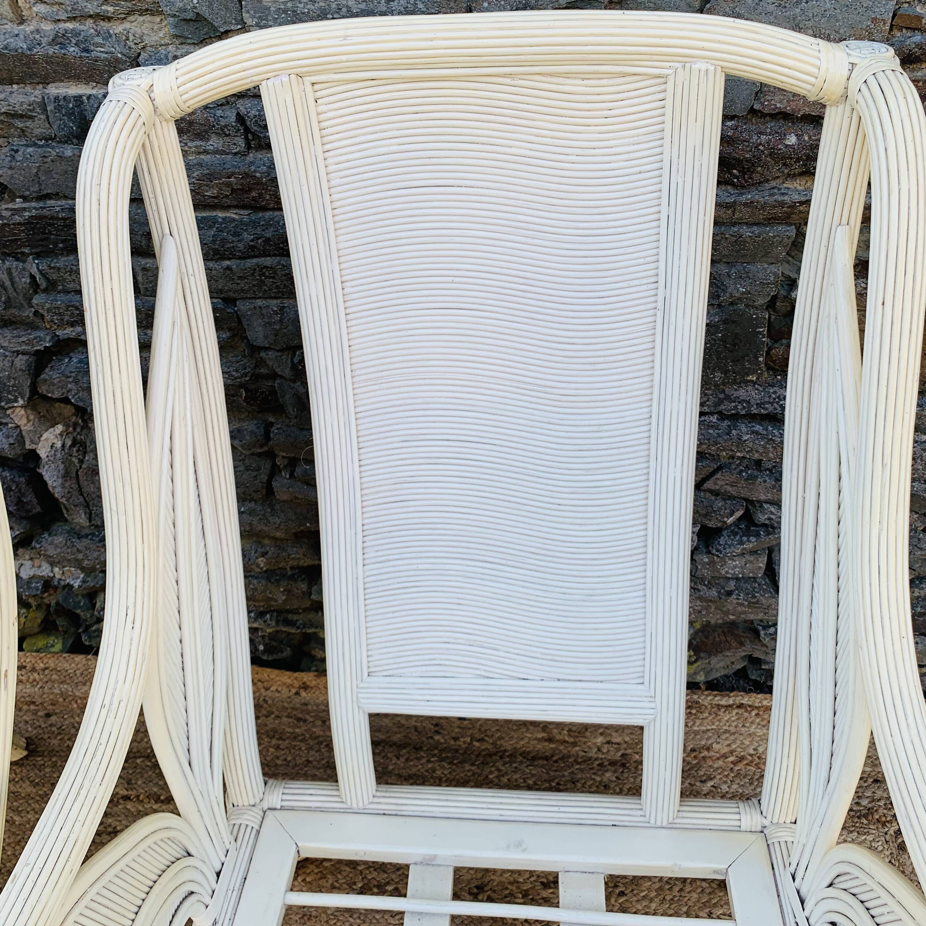 Pair of white rattan armchairs