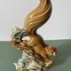 Ceramic squirrel on branch