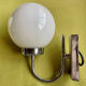 Pair of chrome metal wall lights with white glass globe.