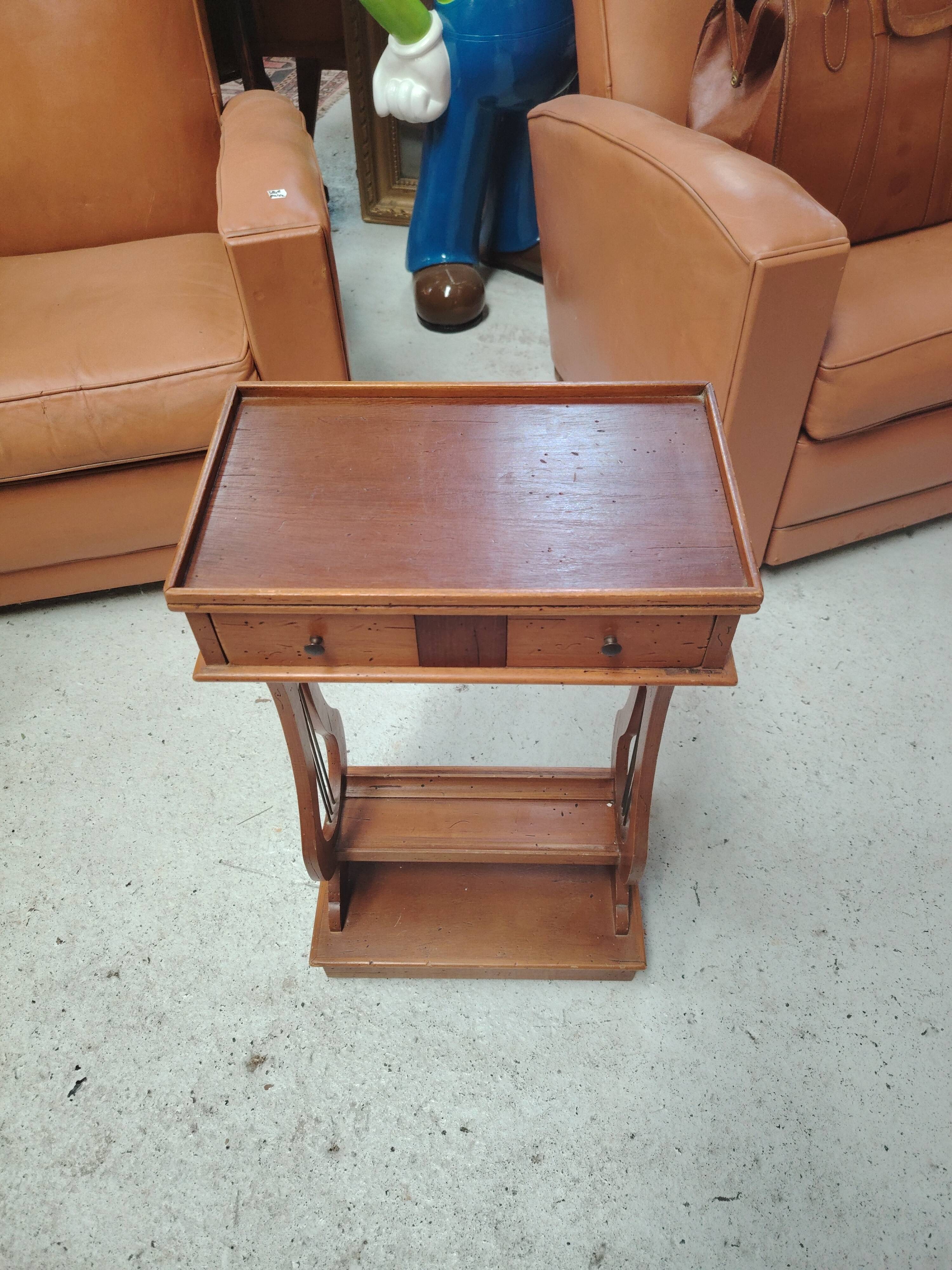 Vintage end table with lyre legs and two drawers.