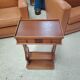 Vintage end table with lyre legs and two drawers.